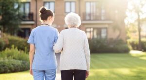 Older adult and family member organize labeled boxes and personal belongings in an assisted living apartment.